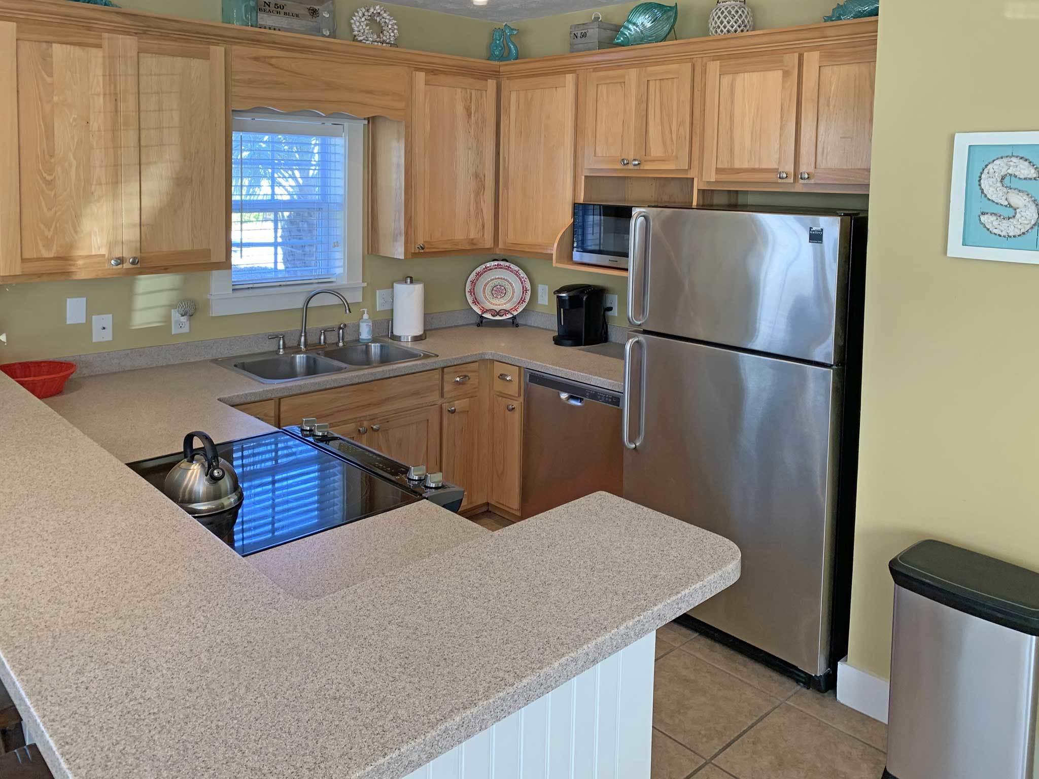 167 Beach Bike Way Inlet Beach, FL 32461 - Photo 6 of 22 a kitchen with a refrigerator a stove a sink and a cabinets
