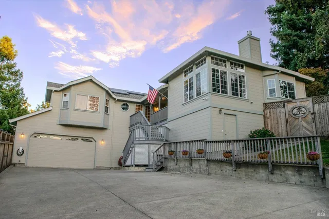 a view of a house with a wooden fence
