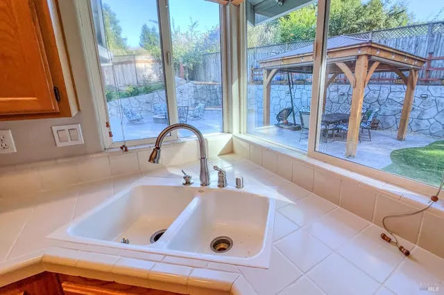 a kitchen with a sink and a large window