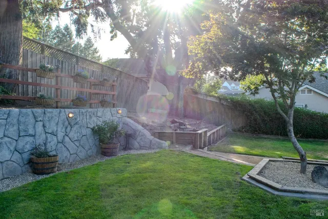 a view of a house with backyard and sitting area