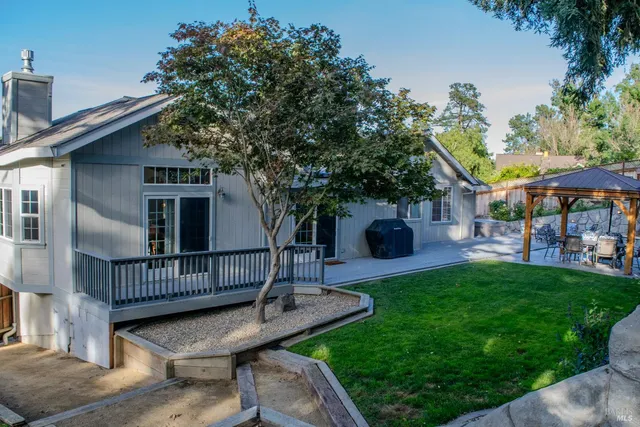 a view of a house with backyard and sitting area