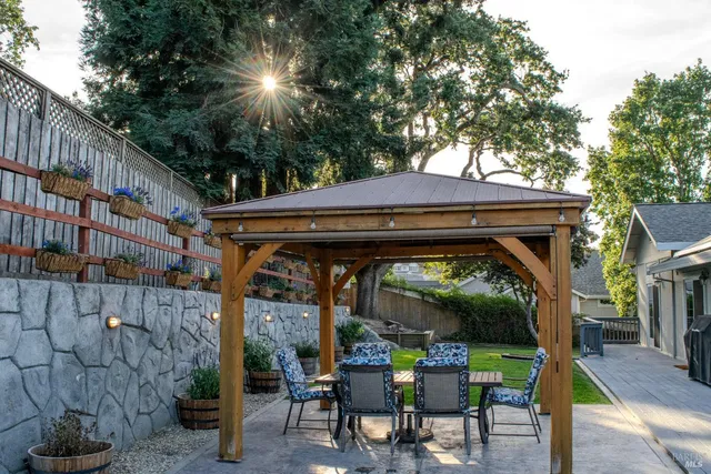 a view of outdoor space with barbeque and wooden fence