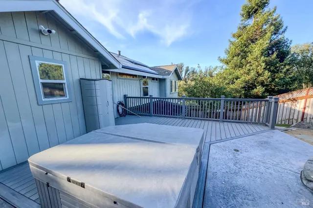 a view of a balcony with chairs and wooden fence