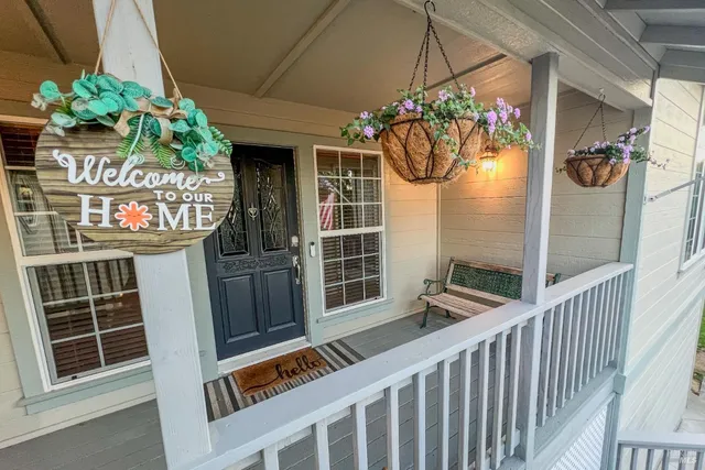 a view of a porch with a table and chairs