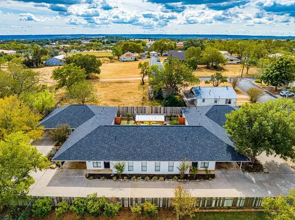 an aerial view of residential houses with outdoor space