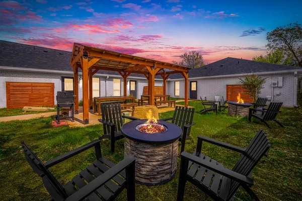 a view of a house with backyard and a patio