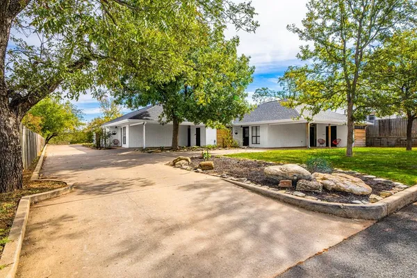 a front view of house with yard and green space