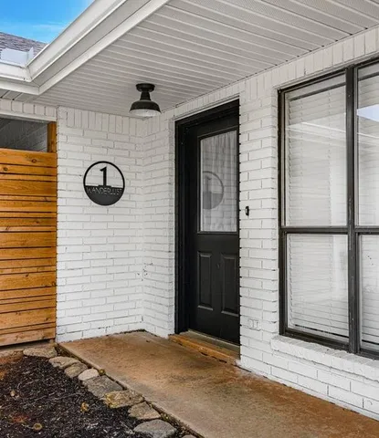 an aerial view of a house with a yard and lake view