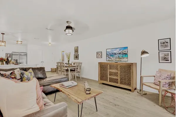 a living room with furniture and wooden floor