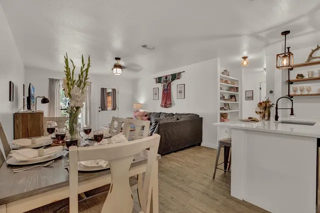 a view of living room kitchen with furniture and wooden floor
