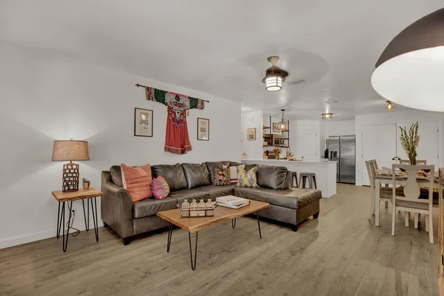 a living room with furniture and wooden floor