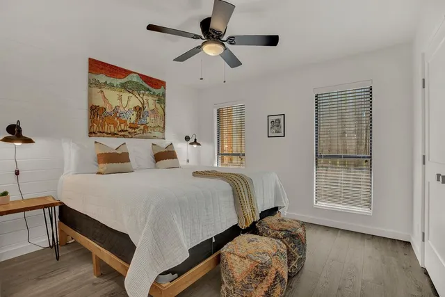 a bedroom with a bed and a window