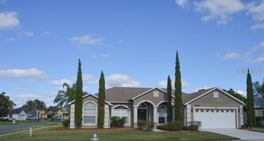 3266 Countryside View Drive St. Cloud, FL 34772 - Photo 1 of 1 a front view of a house with garden