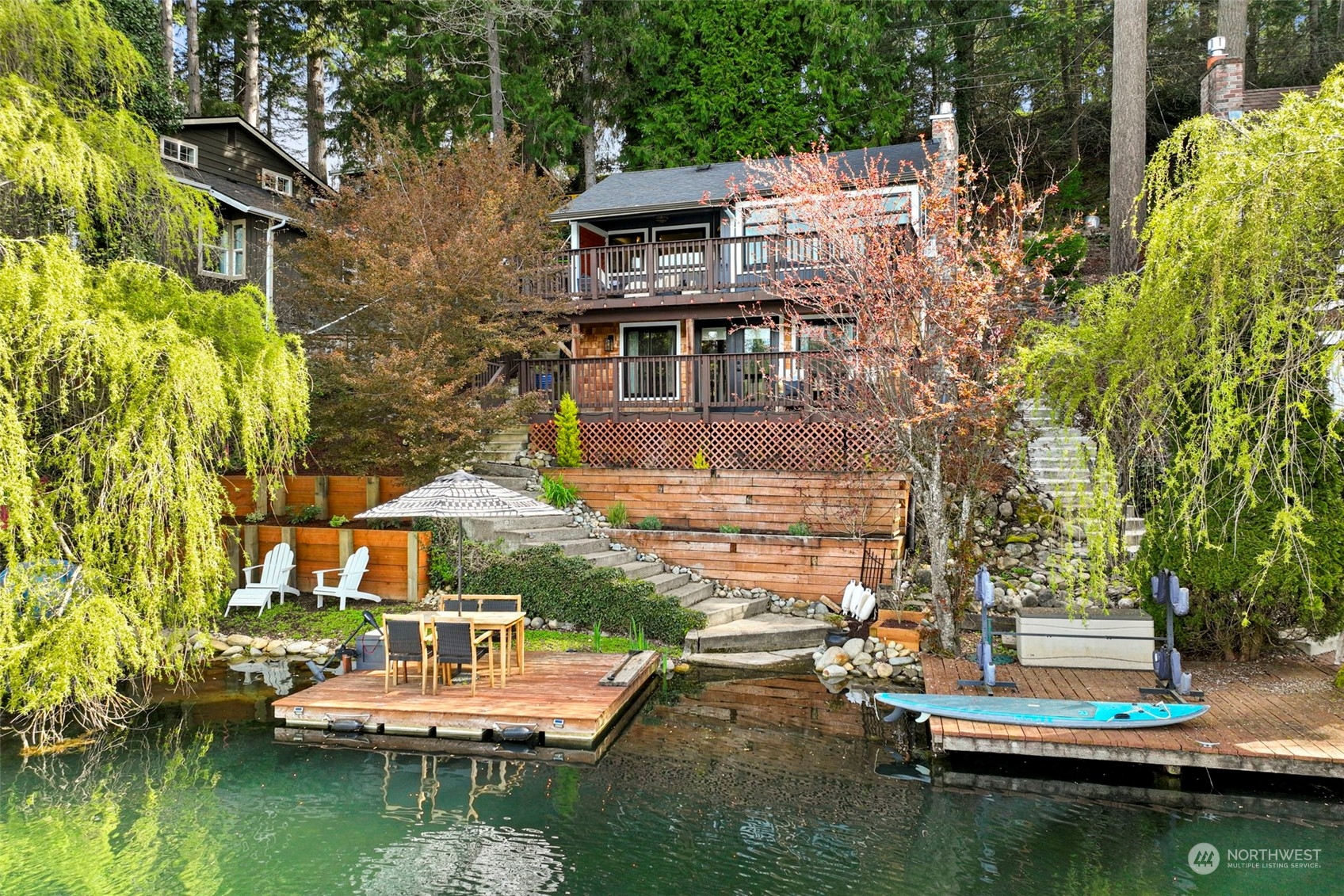 a view of house with swimming pool and outdoor seating