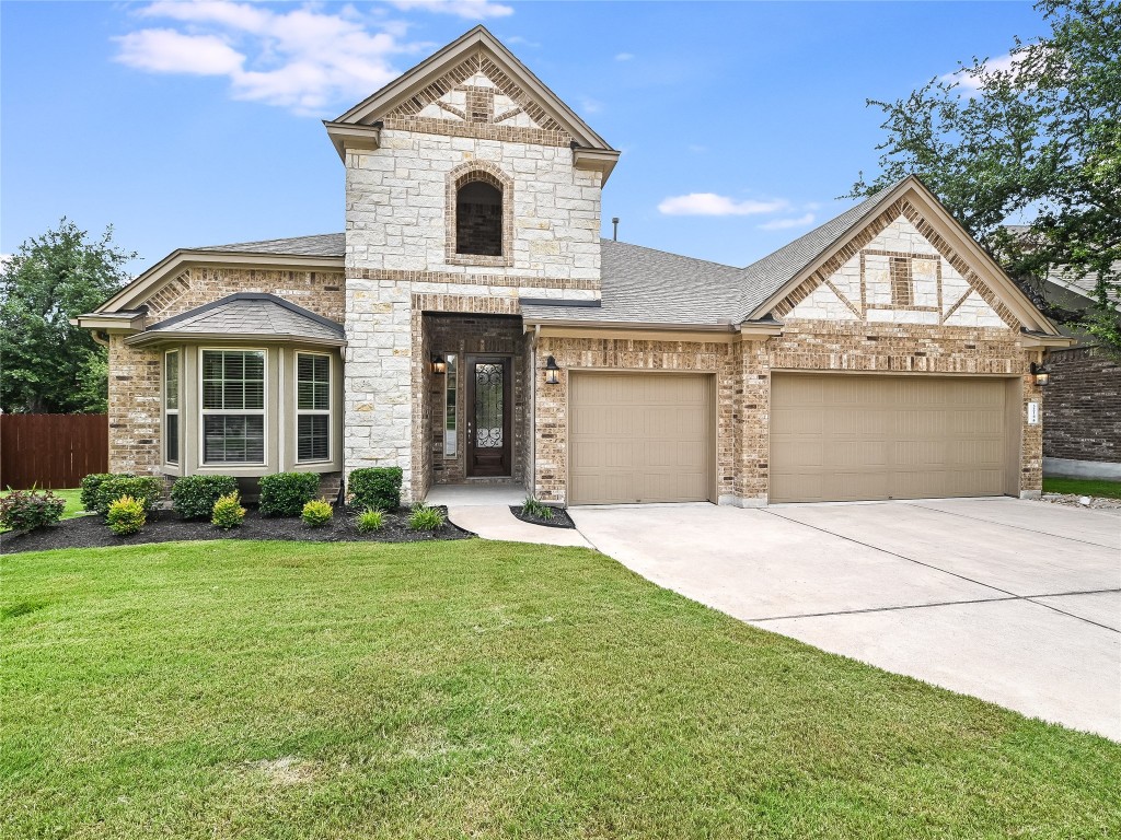 3214 Winged Elm Drive Cedar Park, TX 78613 - Photo 1 of 1 a front view of a house with a yard and garage