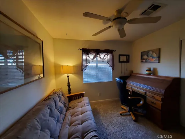a bedroom with furniture and a ceiling fan