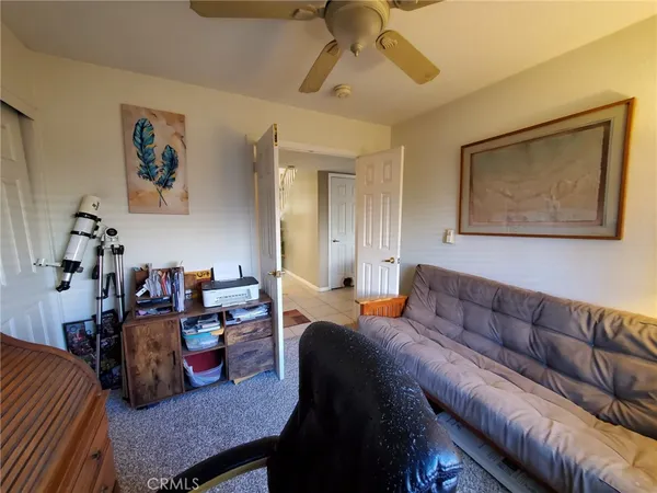 a bedroom with furniture and a ceiling fan