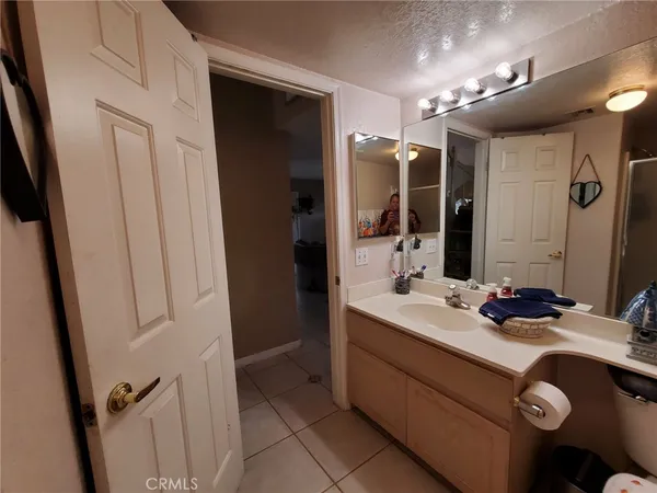 a kitchen with sink and refrigerator