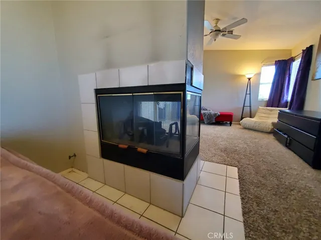 a living room with a bed and a chandelier