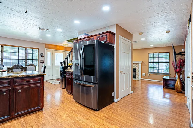 a kitchen with stainless steel appliances granite countertop a refrigerator and a sink