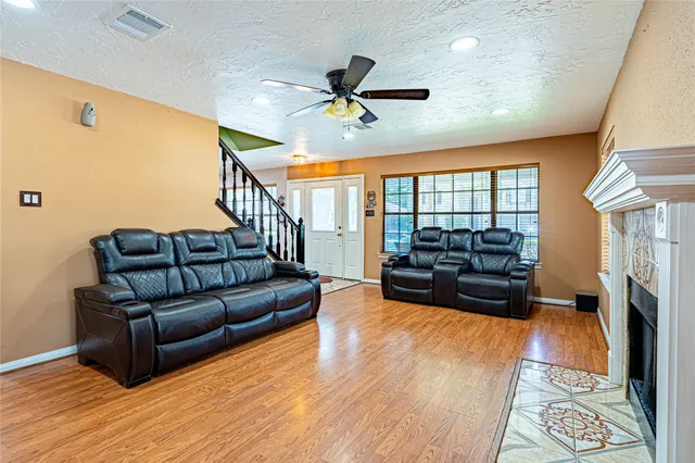 a living room with furniture ceiling fan and a rug