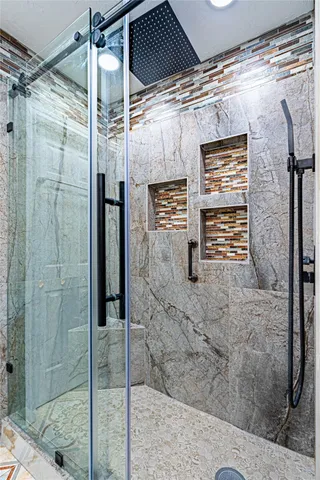 a bathroom with a shower and a sink