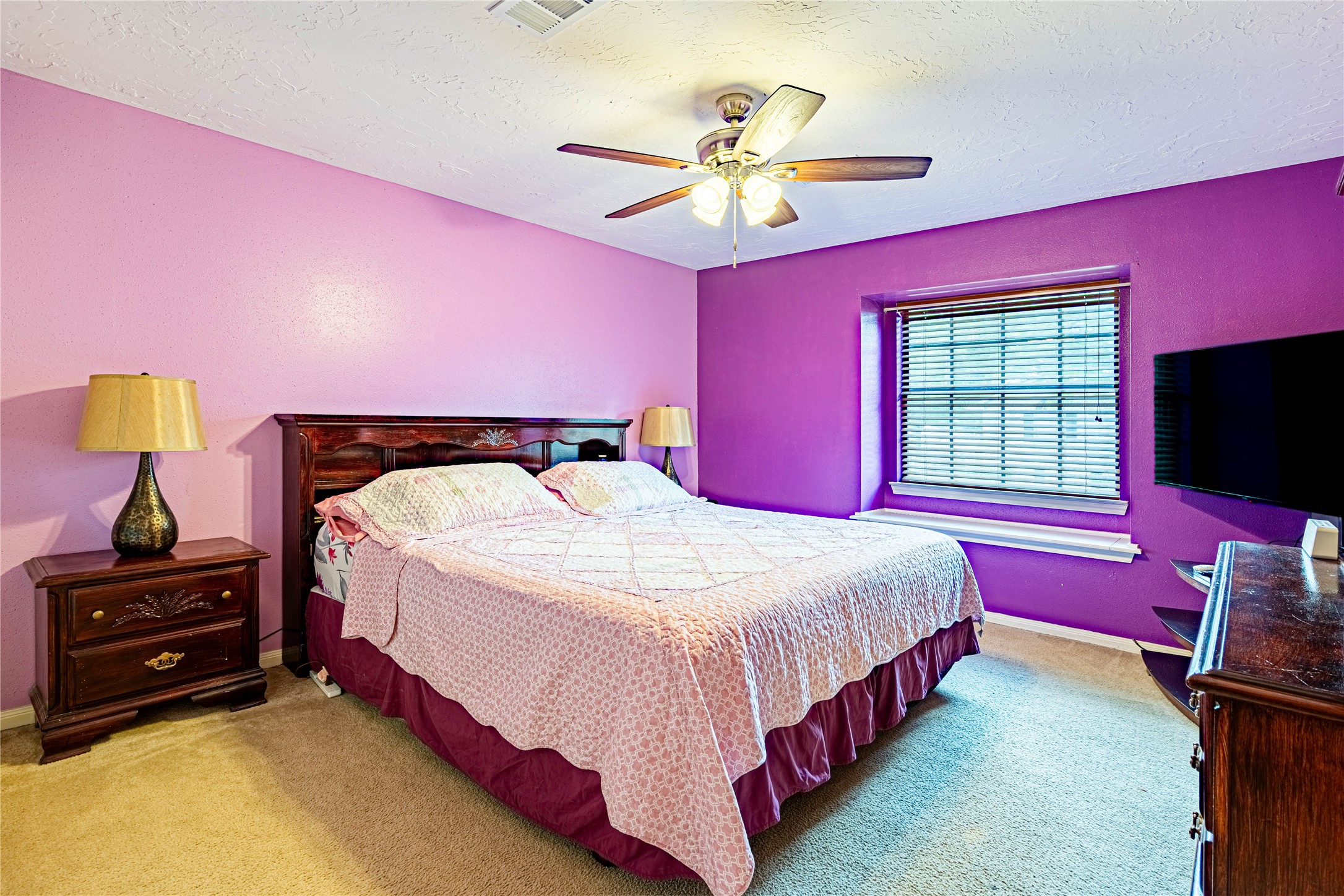 3403 Berry Grove Drive Spring, TX 77388 - Photo 31 of 43 a bedroom with a bed and a chandelier
