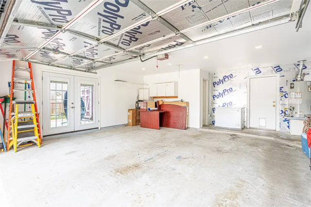 a utility room with dryer and bicycles