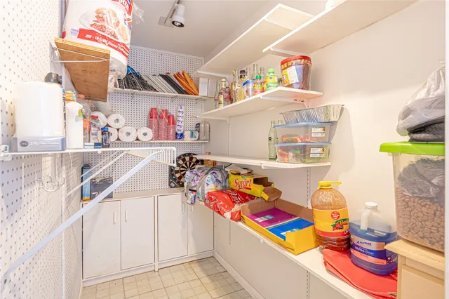 a view of a patio with a table and chairs under an umbrella