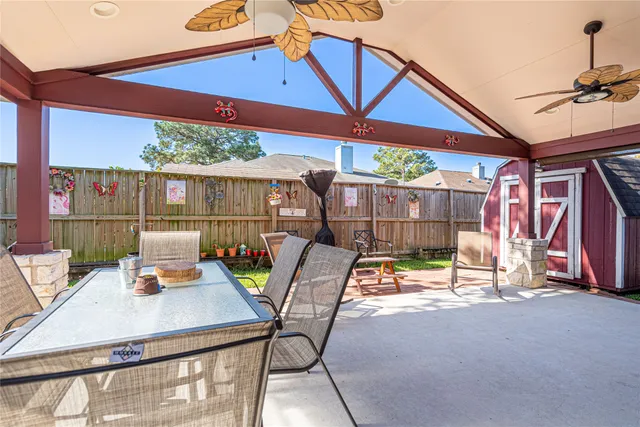 a view of a patio with a table and chairs under an umbrella