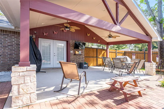 a view of a chairs and table in back yard of the house