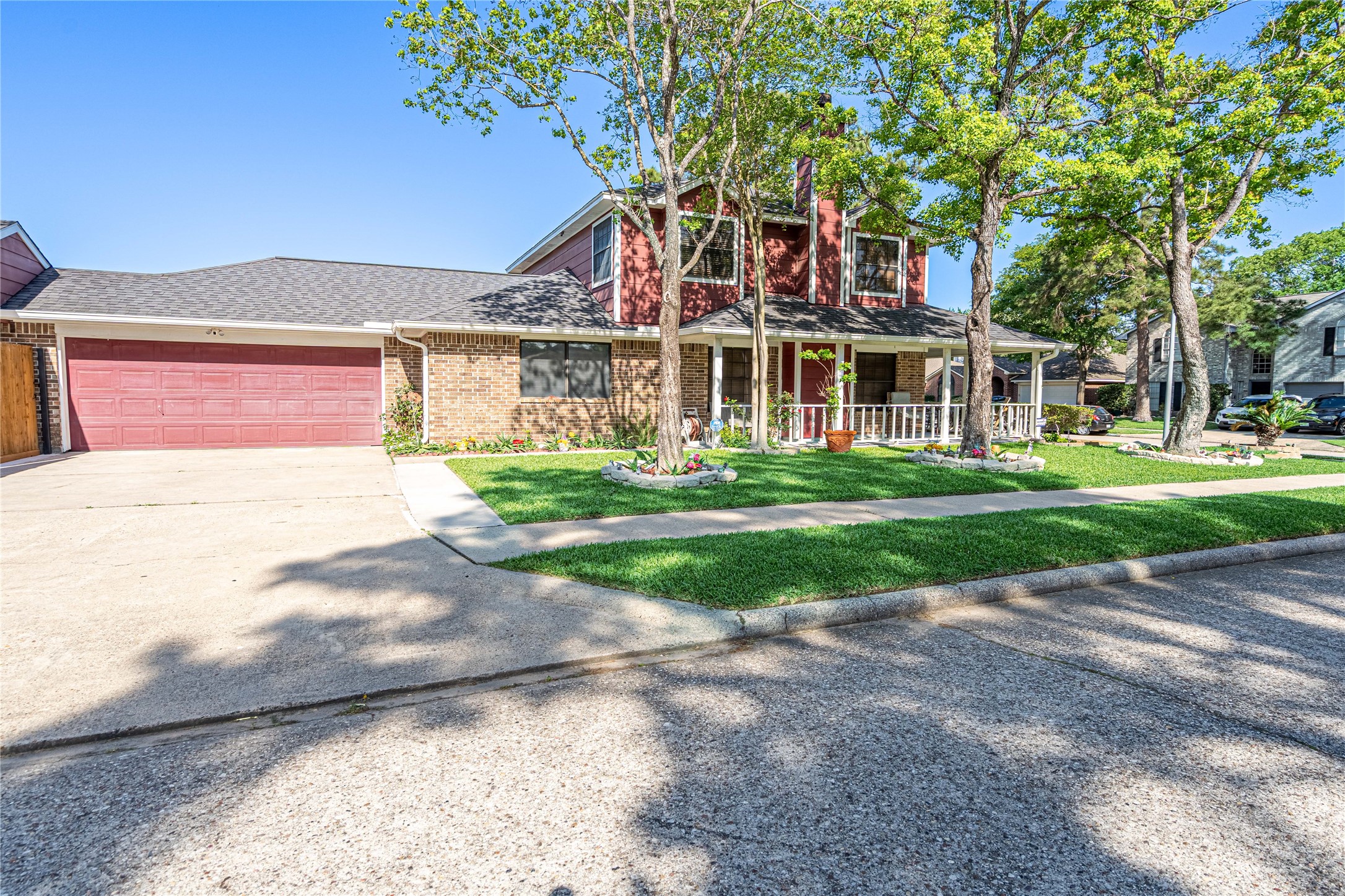 3403 Berry Grove Drive Spring, TX 77388 - Photo 4 of 43 a front view of a house with a yard and potted plants