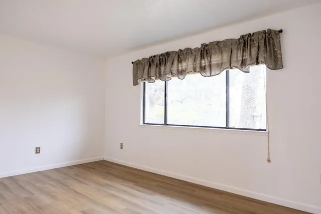 a bathroom with a granite countertop sink toilet mirror and shower
