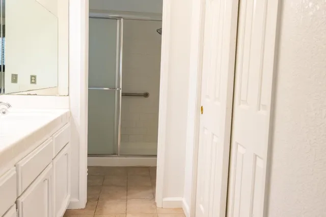 a bathroom with a glass shower door
