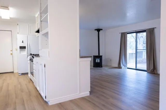 a kitchen with granite countertop a stove and cabinets