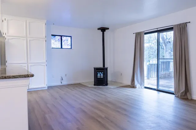 a kitchen with granite countertop a refrigerator and a sink