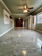 401 North 11th Street West Columbia, TX 77486 - Photo 2 of 15 a view of empty room with a ceiling fan and window