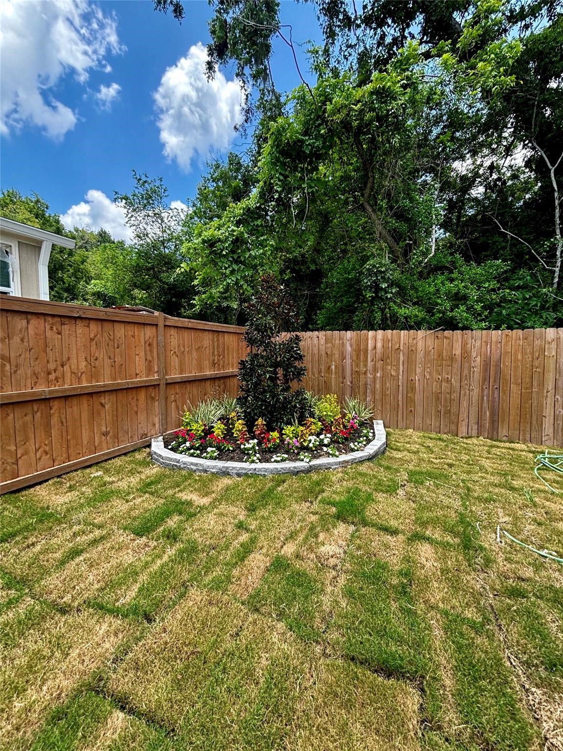 401 North 11th Street West Columbia, TX 77486 - Photo 10 of 15 a view of a backyard with table and chairs and wooden fence