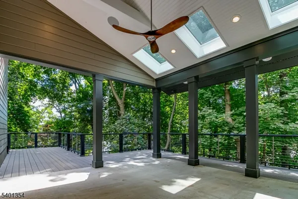 a view of a couches in the patio next to a yard