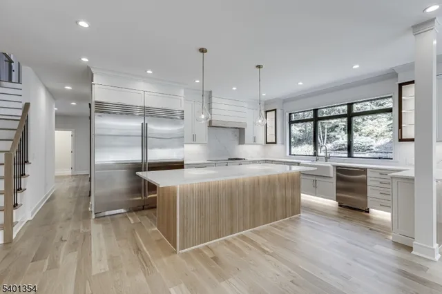 a view of a hallway with wooden floor and a potted plant