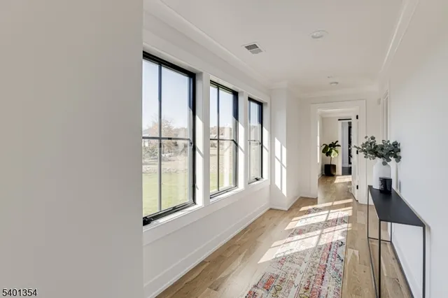 a view of a kitchen and dining room with wooden floor