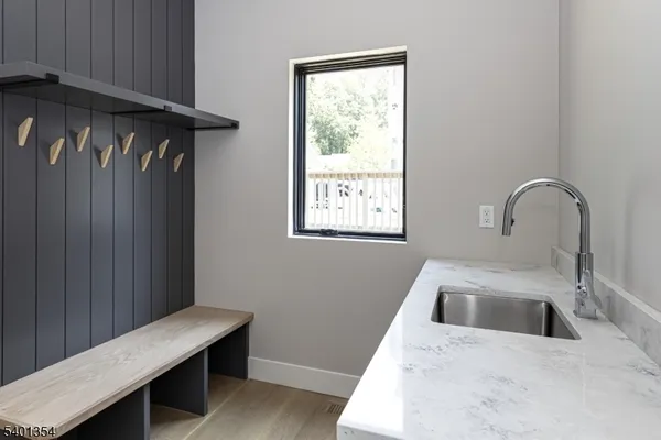 a kitchen with a sink a table and chairs