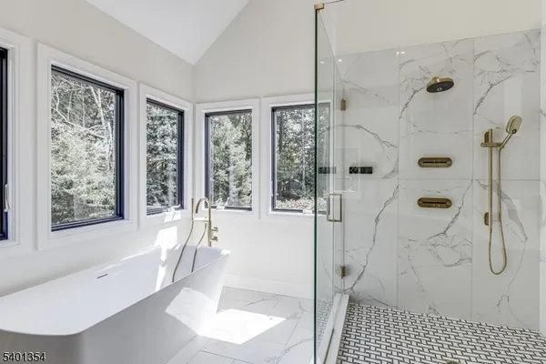 a bathroom with a bathtub and a shower