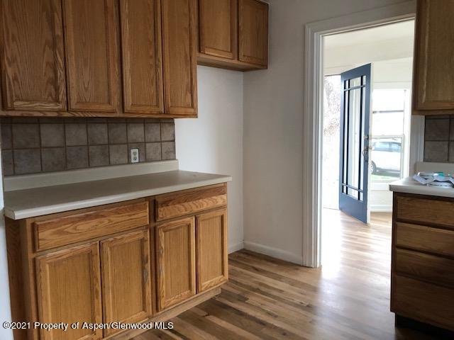 121 West 6th Street Rifle, CO 81650 - Photo 3 of 8 a view of a kitchen with wooden floor