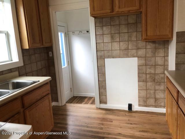 121 West 6th Street Rifle, CO 81650 - Photo 4 of 8 a kitchen with stainless steel appliances a refrigerator and a sink