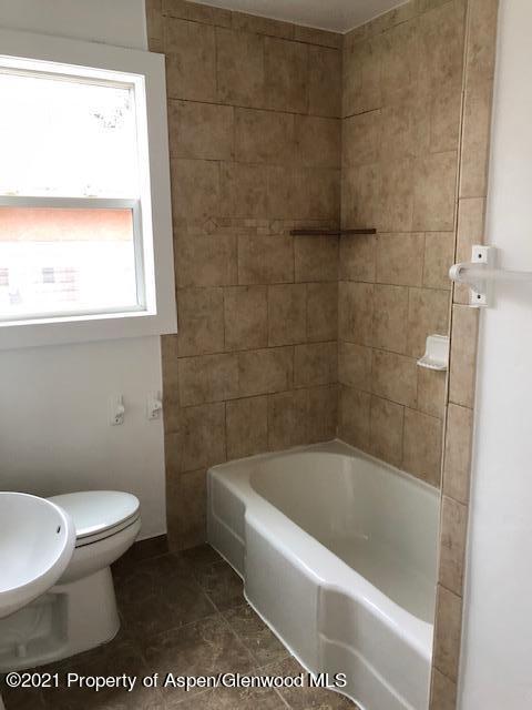 121 West 6th Street Rifle, CO 81650 - Photo 6 of 8 a bathroom with a toilet and a bathtub