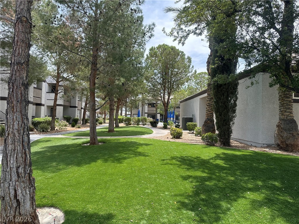 7255 West Sunset Road, Unit 2006 Las Vegas, NV 89113 - Photo 3 of 24 Manicured green spaces create a serene environment within the community.