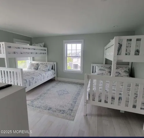 a bedroom with furniture and baby crib