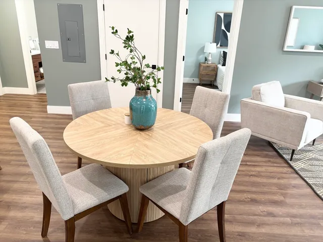 a view of a dining room with furniture and wooden floor