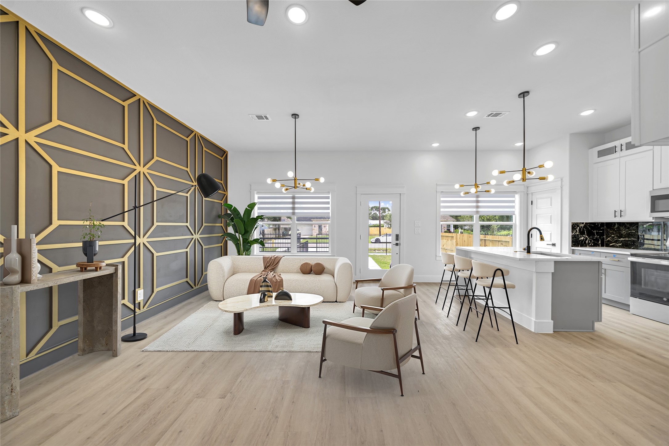 a kitchen with stainless steel appliances kitchen island granite countertop a stove a sink a dining table and chairs with wooden floor